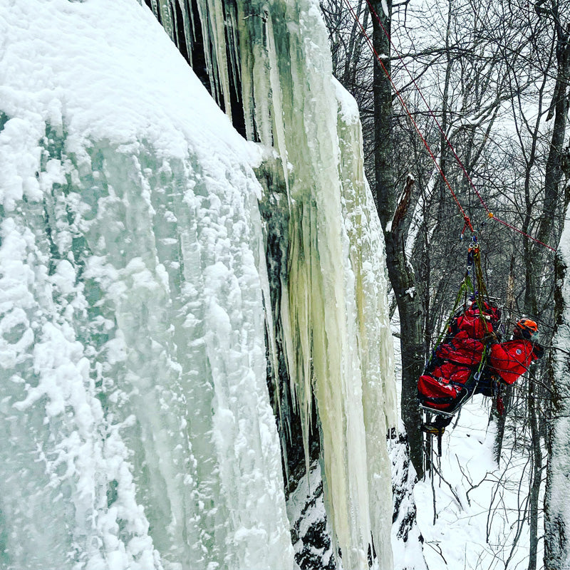 Instructor demonstrating a rescue on an ice wall